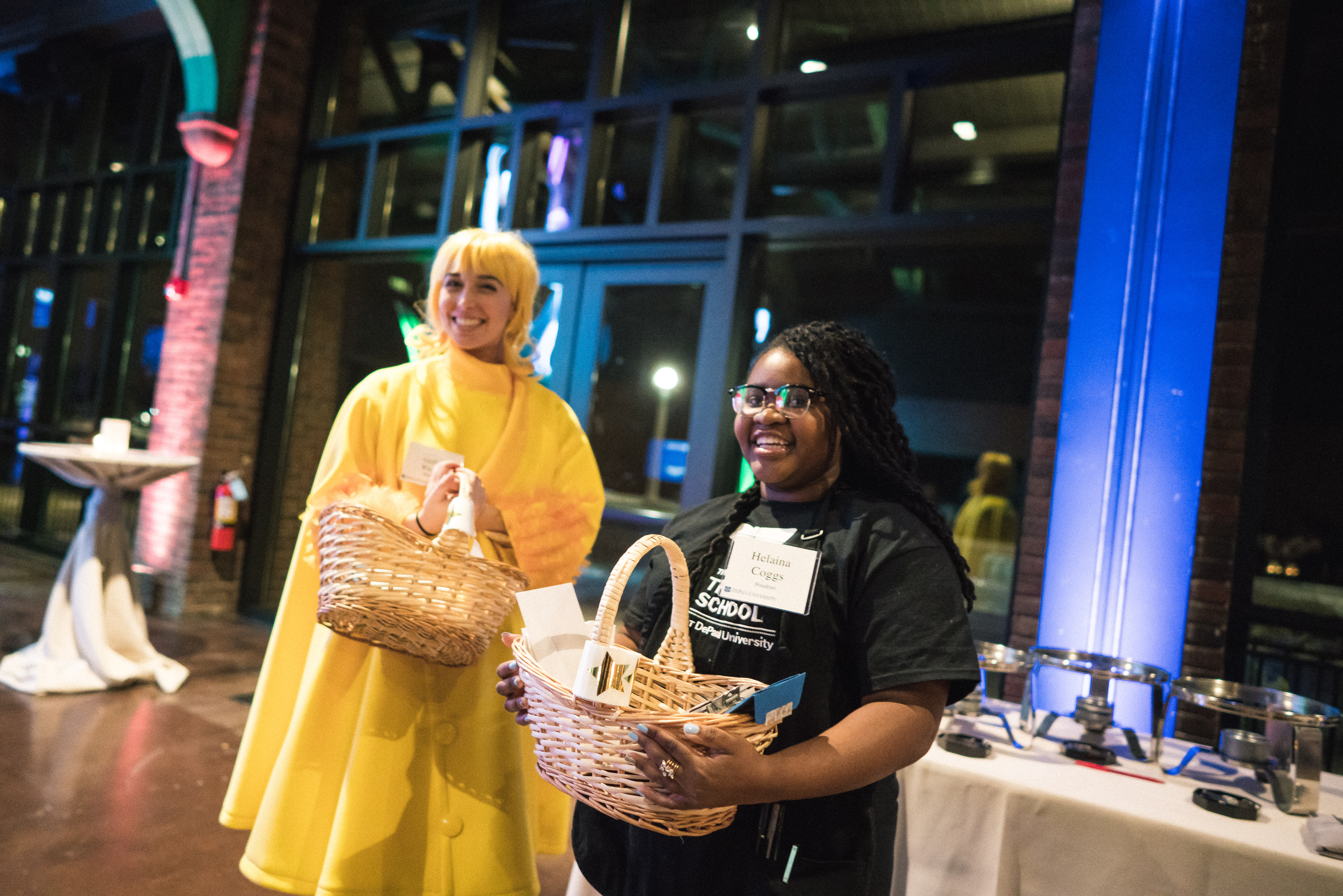 Students Geffen Wiener and Helaina Coggs encouraging attendees to purchase raffle tickets to support The Theatre School.
